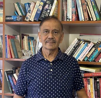 Pragnesh Mehta at his practice, in front of his bookshelves